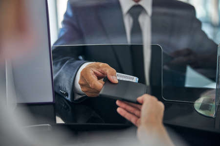 Man giving documents for checking in at airport