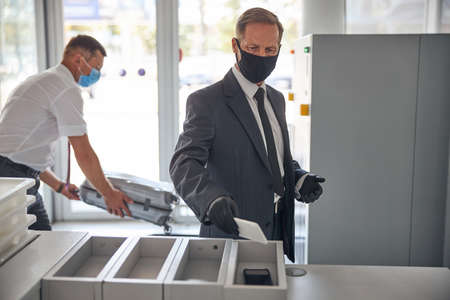 Elegant male walking through customs in airport