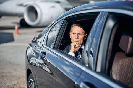 Mature elegant man during transfer after landingの写真素材