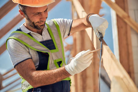 Positive delighted constructor making mark on the beam