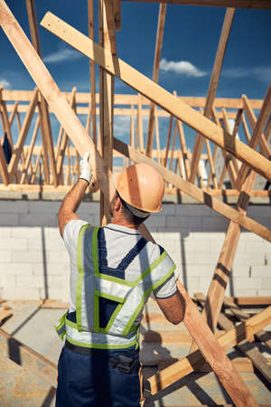 Busy constructor going to hammer the beamの写真素材
