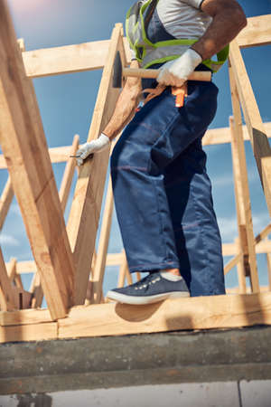 Profile photo of strong man that standing on the beamの写真素材
