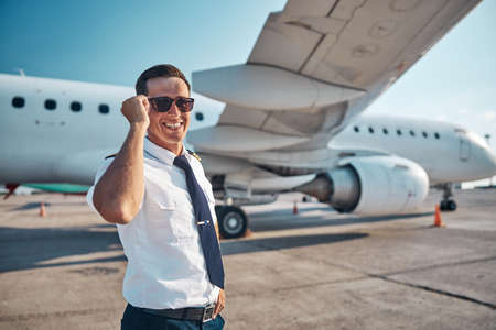 Joyful attractive pilot looking forward to flightの写真素材