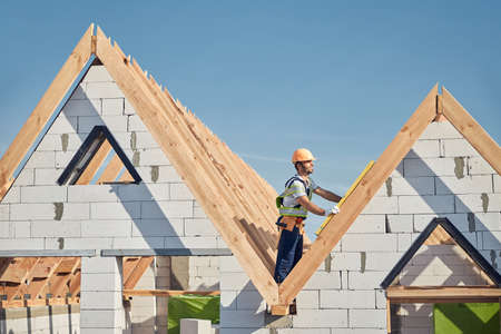 Professional construction worker standing on top of a buildingの写真素材