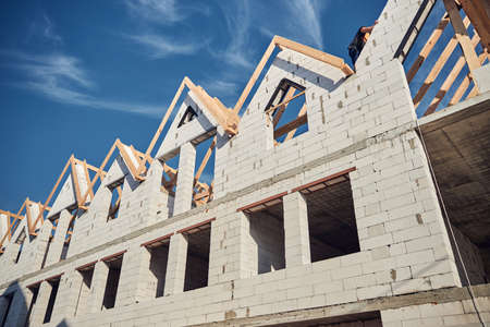 Professional worker climbing on top of a white buildingの写真素材