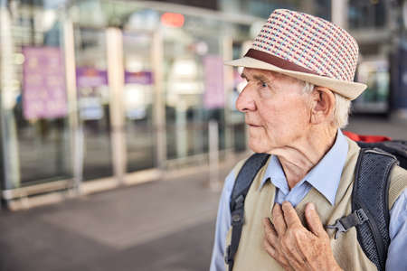 Scared aged Caucasian traveler looking at somethingの写真素材
