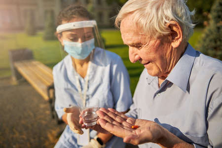 Calm patient accepting medicament from a doctor