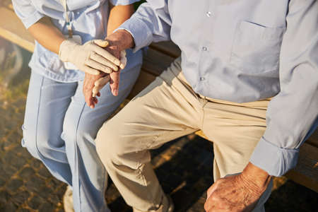 Doctor physician holding hand of an old patientの写真素材