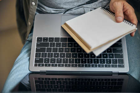 Working man with a notepad and a portable computer