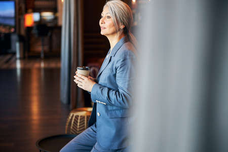 Beautiful elegant woman holding cup of coffeeの写真素材