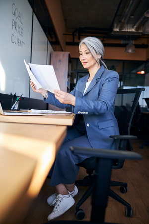 Charming woman working on project in modern officeの写真素材