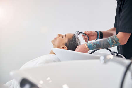 Unknown stylist and a model in a robe with the closed eyesの写真素材