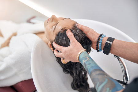 Barber massaging the head of the clientの写真素材