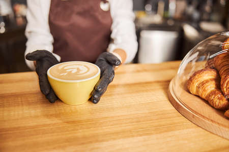 Barista demonstrating fresh hot coffee in the cafeの写真素材