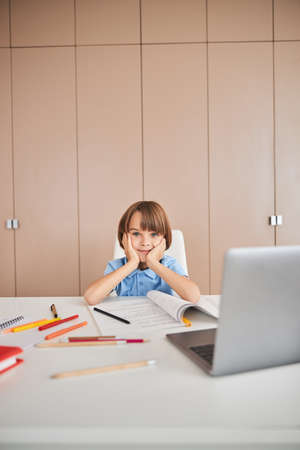 Child feeling impressed by the first day of distant learningの写真素材