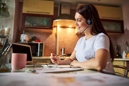 Nice person talking through a headset and writing the results
