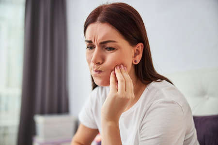 Poor adult woman is having a toothache