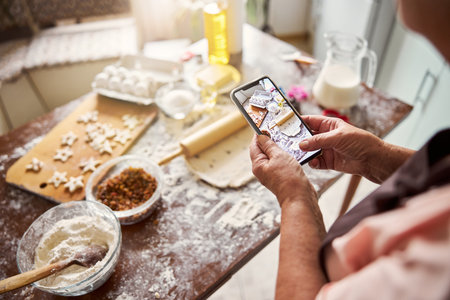 Culinary blogger taking a picture of messy kitchen table