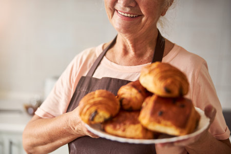 Fragment photo of happy grandma holding fresh pastriesの写真素材