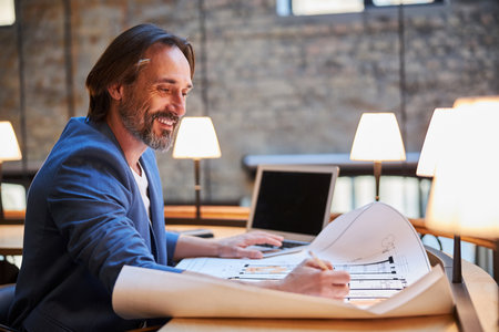 Gladsome businessman doing some paperwork with pleasureの写真素材