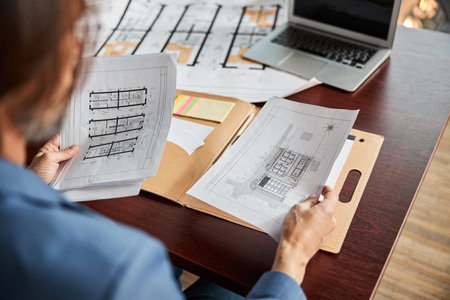 Hard-working office employee checking paperwork at the desk