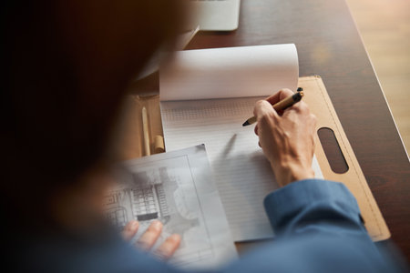 Hard-working man dealing with paperwork at the table