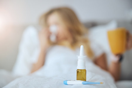 Focused photo on nose drops that standing near thermometerの写真素材