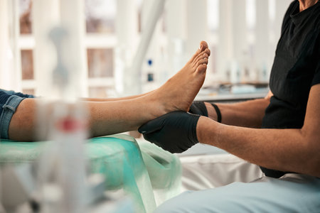 Close up of competent doctor doing foot massageの写真素材
