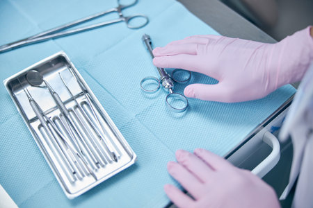 Dentist using sterile instruments during work in office