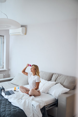 Stylish charming female spending weekend at the beauty skin procedure in home apartmentsの写真素材