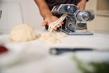 Dough being processed through the pasta machine