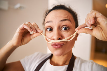 Being in good mood while cooking pastaの写真素材