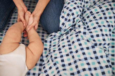 Close up of female hands holding little feet