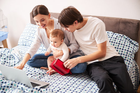 Happy young parents playing with their kidの写真素材
