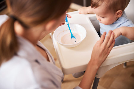 Careful young parent taking care of her childの写真素材