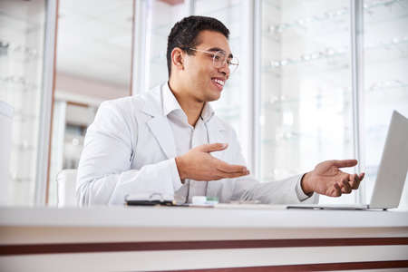 Professional male ophthalmologist giving an online consultationの写真素材