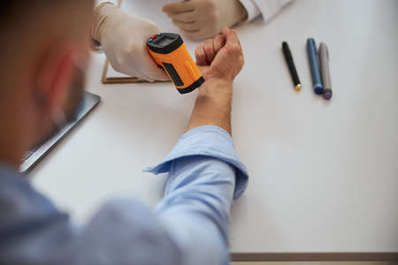 Professional male doctor working with patient in room indoors in hospitalの写真素材