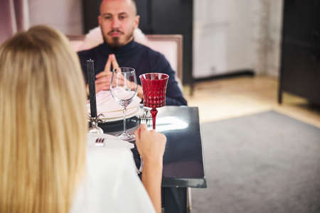 Handsome man sitting in a restaurant with his girlfriend