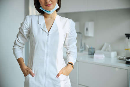 Doctor with her hands in her pockets standing at workの写真素材