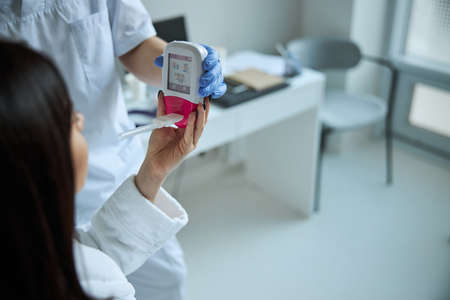 Patient receiving a spirometer from the physician handsの写真素材