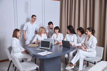 Doctors discussing their patient cases at a brief meetingの写真素材