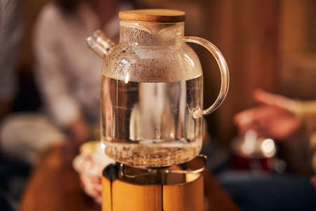 Glass teapot with water on portable gas burner