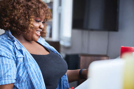 Lovely plus-size lady enjoying morning at her houseの写真素材