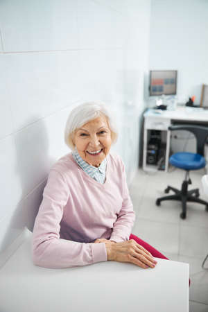 Elderly woman sitting in a stomatological office