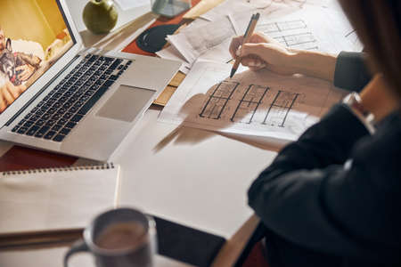 Architect making corrections to a house plan with a ball-point penの写真素材