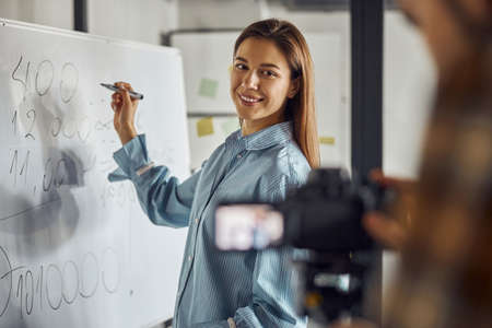Joyous female engineer posing for the camera in the workplace