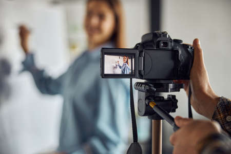 Woman engineer filmed by a colleague in the workplaceの写真素材
