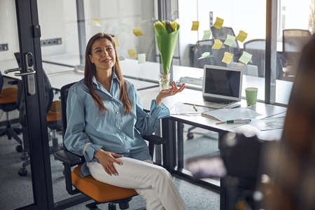 Joyous employee posing for the camera in the workplaceの写真素材