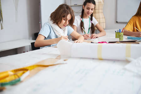 Adorable female children working in sewing workshopの写真素材