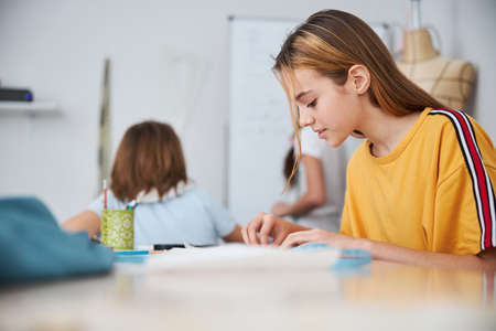 Adorable female child working in sewing workshopの写真素材